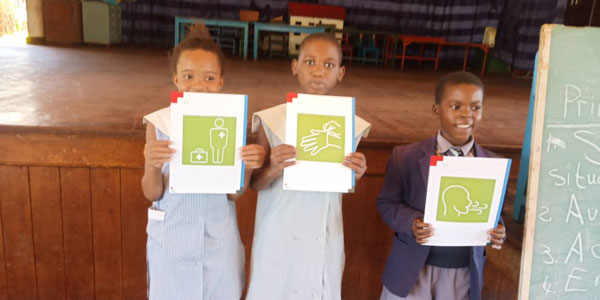 African children hold up instructional images