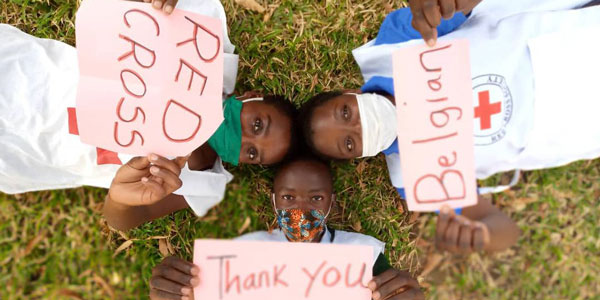 African children hold signs saying 'Thank you Belgian Red Cross'